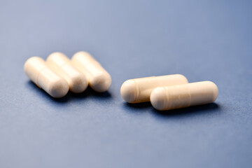 Arginine capsules on bright background. Soft focus. Close up. Copy space.	