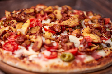 Gyros Pizza with jalapeno pepper, cherry tomatoes and mozzarella cheese. Soft focus. Close up.