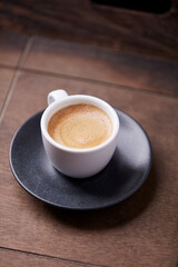 Cup of coffee on wooden background. Soft focus. Copy space	