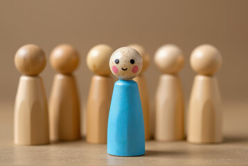 A colorful wooden peg doll, figure, stands out among neutral-toned figures, symbolizing individuality and uniqueness in a group setting.