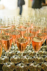 Many Glasses of Pink Champagne Ready for a Toast