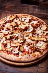 Gyros Pizza with with champignons and mozzarella cheese. Wooden background. Soft focus.	