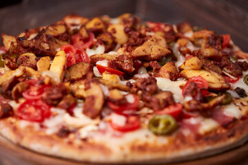 Gyros Pizza with jalapeno pepper, cherry tomatoes and mozzarella cheese. Soft focus. Close up.	