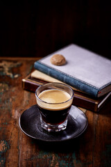 Coffee in glass cup on dark background. Close up. Copy space	