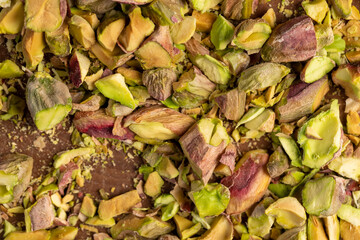 green pistachios for cooking , chopped into pieces crispy pistachios fried with salt, closeup