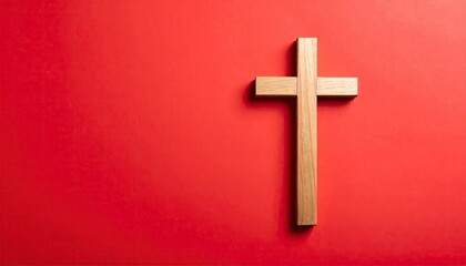 Simple wooden cross on red background