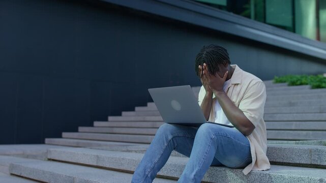 Stressed man facing financial crisis outdoors