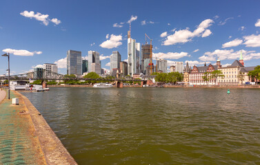 Obraz premium View of the skyline and the Main River with Alte Bruecke bridge in Frankfurt am Main Germany on a clear summer day