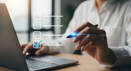 Photo of a woman uses a pen to check off items on a virtual checklist displayed on a transparent screen while working on her laptop