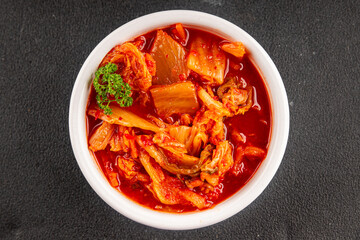 Kimchi pickled cabbage salad spicy savory vegetables fresh delicious gourmet food background on the table rustic food top view copy space vegetarian and vegan food