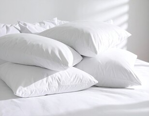Stack of white pillows on a bed