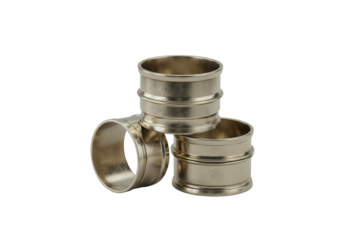 Set of three metallic napkin rings with textured design on white background  
