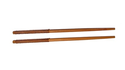A pair of wooden chopsticks placed on a white background. Two wooden chopsticks made of wood. Wooden chopsticks are tools for eating. Wooden chopsticks. Viewed from above.