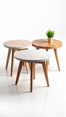 Three round side tables in light wood tones