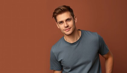 Confident young man with captivating gaze posing against vibrant brown backdrop