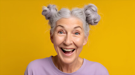 Portrait of surprised senior woman showing excitement on yellow background