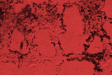 Red background, Rough textured red wall with visible cracks and dark abstract patterns, ideal for backgrounds and art projects.