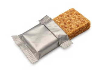 Silver-wrapped nutrition bar providing quick energy, lying beside unwrapped portion against clean transparent backdrop