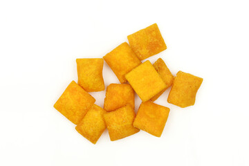 Pile of orange square shaped protein snack isolated on white background