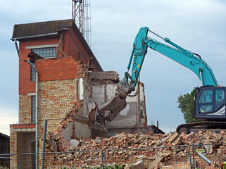 Old Building Teardown - Urban Renewal: Heavy Machinery Tearing Down a Structure for New Development