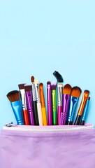 Obraz premium Colorful Makeup Brushes in a Purple Pouch on Blue Background