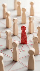 Obraz premium Isolated red figure among wooden figures connected by red threads image