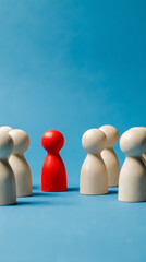 Red figure stands out among pale figures conceptual wooden