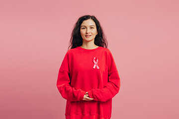 Woman wearing pink ribbon showing support for breast cancer awareness
