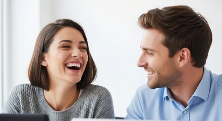 Young business professionals sharing a laugh in a bright modern office