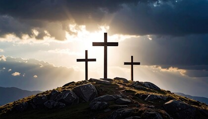 Three crosses on a mountaintop at sunset