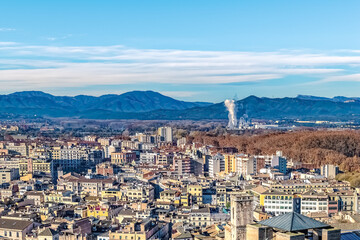 Panoramic winter view of Girona, Spain, with colorful buildings, autumn foliage, and the Pyrenees...
