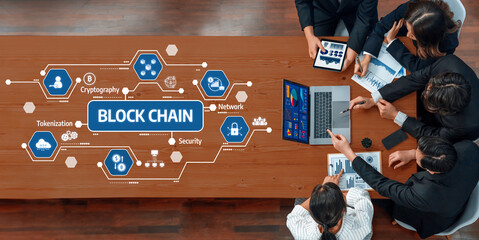 A business team collaborates in a modern office setting, focusing on blockchain technology and security strategies. Engaging discussions are supported by digital displays and data visuals. Amity