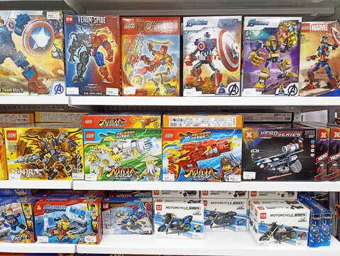 Assorted building block toys on store shelf featuring superhero and ninja themes