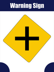 Four-Way Intersection Warning Sign for Road Safety. A yellow diamond-shaped road sign showing a black cross symbolizing an upcoming four-way intersection.