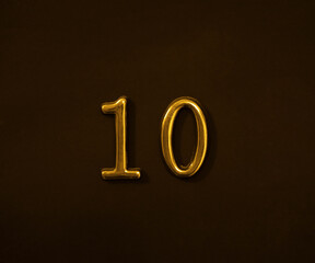yellow gold golden  ten 10 Number Write isolated On black Dark Wall door Background. white 10...