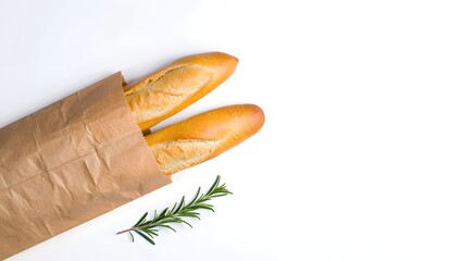 Fresh baguette bread in paper bag with rosemary on white background food photography
