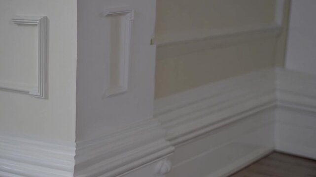 detailed close-up of an ornate white baseboard molding in an empty room, offering ample copy space for design inspiration