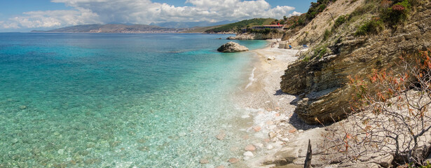 Obraz premium stunning Pulebardha Beach in Ksamil, Albania. Saranda city on background