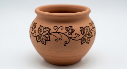 Decorative ceramic pot with leaf motif on neutral background