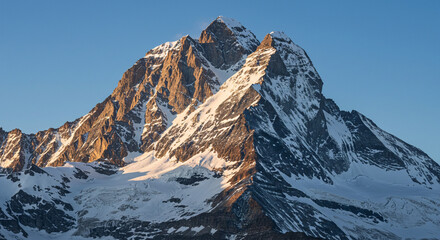 Alpine Mountain Vista with Snow-Covered Summit and Rugged Stone Crevices