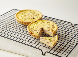 Smoked Ham and Mozzarella Quiche with Slice on Cooling Rack side view of breakfast or brunch menus