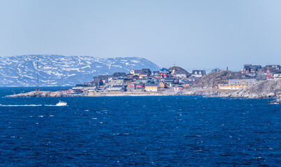 Collection of homes with Hans Egede statue on hilltop by Church of our Saviour in Nuuk in Greenland