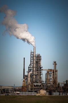 Oil Refinery With Steam Streaming out of the Stack. Oil refinery producing petroleum products in the Pacific Northwest. 