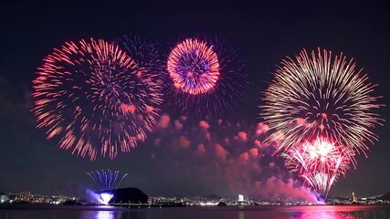 Fireworks Exploding Over Coastal Shoreline at Night