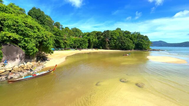 tropical beach in thailand Patong Beach on the island of Phuket Thailand. Lovely turquoise blue waters of the Andaman lush green mountains and white sandy beaches