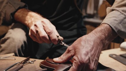 Skilled shoemaker meticulously crafting footwear in traditional workshop