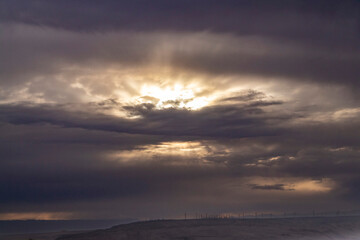 sunset between the clouds resembling a gloomy landscape reminiscent of the apocalypse