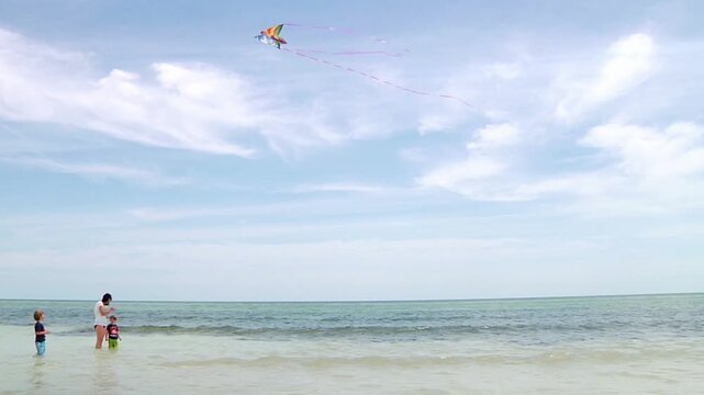 Family flying Kite at ocean in the Florida Keys 
