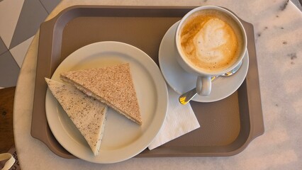 Cozy morning breakfast with cappuccino and sandwiches. Top view. Flat lay