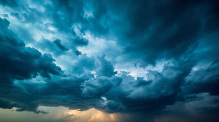 Dramatic blue stormy sky with sunset in the background